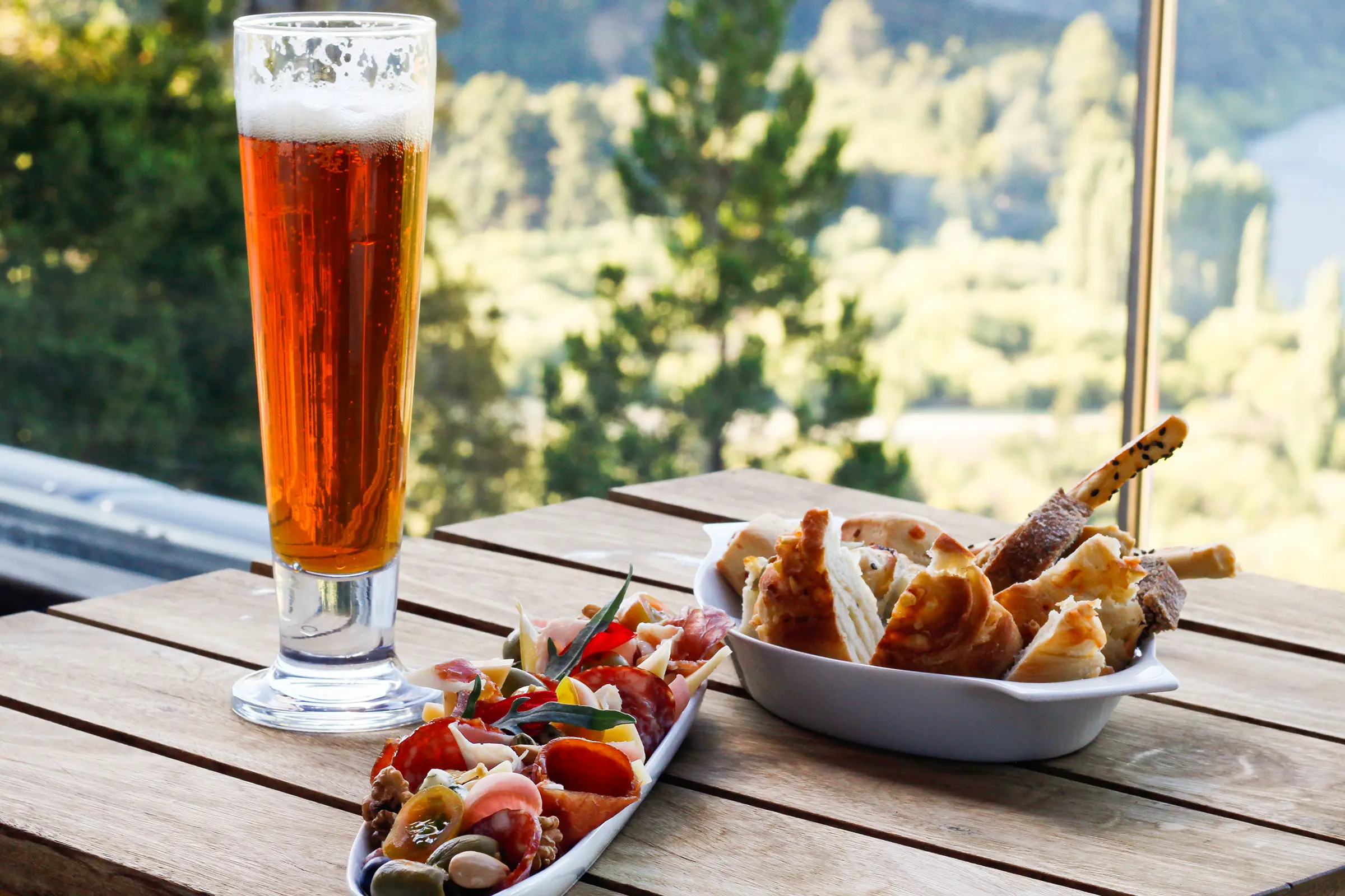 Charcuterie board, artisan breads and beer overlooking the valley